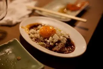 <p>A delicious dish including pork, onion, and egg</p>