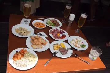 <p>A group of food gathered by some of the guests to enjoy together outside on the patio</p>