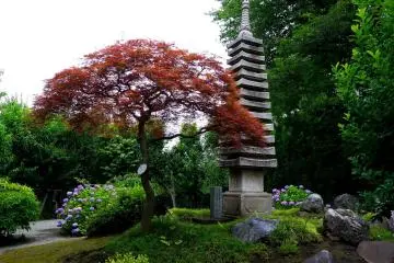 <p>Stone pagoda standing in the well tended garden</p>