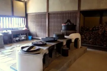 <p>Array of cooking stoves in the earth-floored kitchen &nbsp;</p>