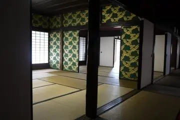 <p>Gold and green wall-paper in a guest room</p>