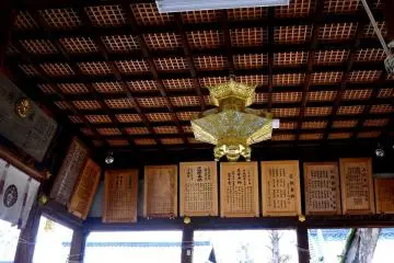 <p>Gold lantern on the ceiling of a shrine building</p>