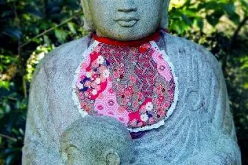 <p>another fascinating structure that you'll see is this Buddha carrying a baby in front of the pagoda.</p>