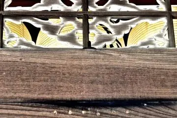 <p>A yellow paper lantern at the front of the temple gate</p>