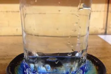 <p>Sake poured into the glass and then overflowing into the saucer - drink both of course!</p>
