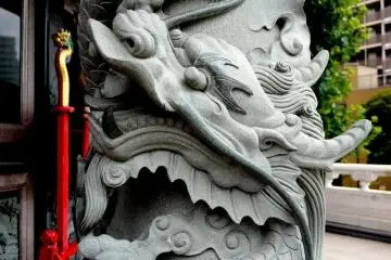Stone dragon clutching a ball