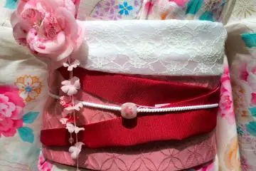<p>Get creative with your Obi by folding it up and then adding an&nbsp;Obi-Jime &amp; Obi-Dome. A decorative string &amp; charm tied around the center of the Obi.</p>