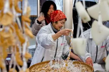 A lesson in stringing up the daikon pieces to dry