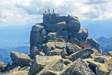 <p>A 'mini canyon' with an open area leading up to the peak of Mount Kinpu</p>