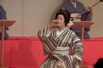 <p>Awara Geigi, Ms. Kurimi, dancing 'Sake and Woman'. This is a gesture depicting a woman drinking sake</p>