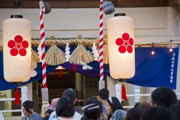<p>A constant line approaches the main shrine, decorated elegantly for the celebration</p>