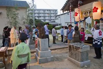 <p>The head priest sits on the left, offering blessings to those approaching the main shrine</p>