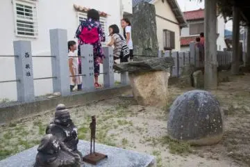 <p>Kids hang out at the back of the shrine grounds</p>