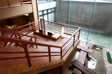 <p>The stairs connecting the first floor lobby and the second floor. There are reclining sofas on the staircase landing</p>