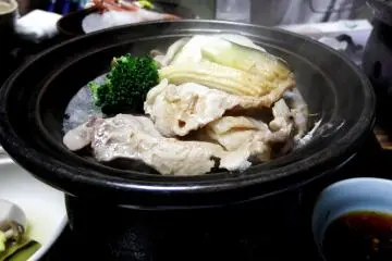 <p>Grilled pork on a small grill. They serve locally-raised pork here</p>