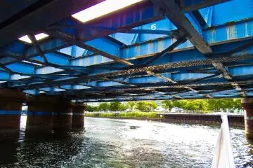<p>Passing under an old railway bridge still used occasionally for transporting freight</p>