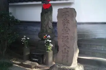 <p>The color red is thought to expel demons and illness. This may be a Jizo Statue, a very common sight in Japan.</p>