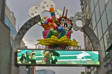 <p>Wave&nbsp;hello to the camera at the entrance of&nbsp;Takeshita Dori&nbsp;or Takeshita Street in Harajuku</p>