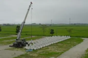 <p>Behind the school are some of the new defences that will be added by the shore. Inland, the ground is going to be raised by 3 metres, and Yuriage will be rebuilt.</p>
