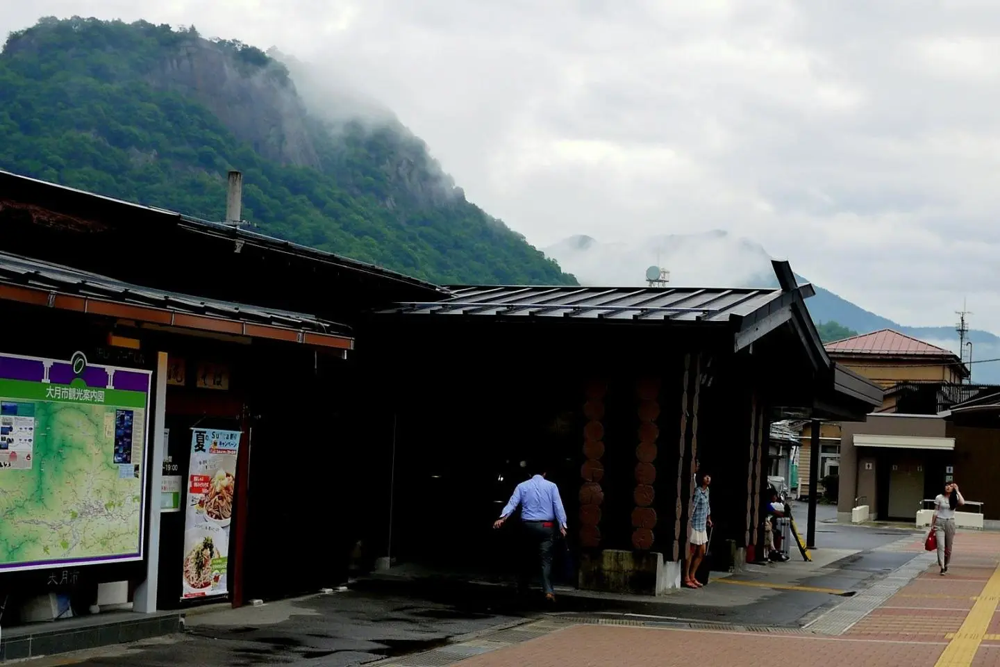 Low cloud touches the rock face of Mount Iwadono