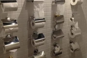<p>Rows of toilet paper rolls in the washroom!</p>