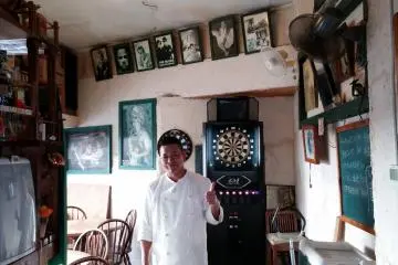 <p>Side seating area and darts board</p>