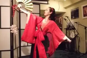 <p>Lady Nana continues to shed clothes around the stage</p>