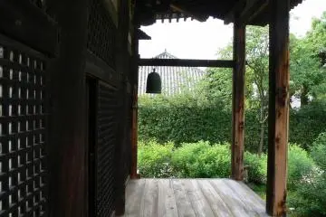 <p>A bell hangs at the end of the verandah</p>