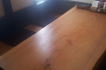 <p>The table is a solid slab of timber</p>