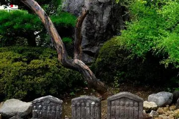 <p>Arrangement with huge rock and small statues</p>