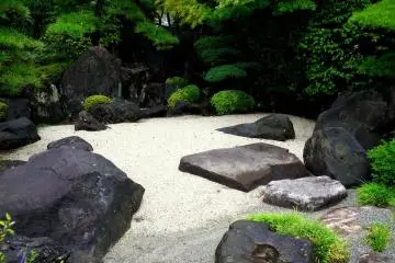 <p>Rocks and sand form a small dry garden</p>