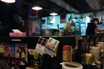 <p>The interior of the store is counter seating around the kitchen area</p>