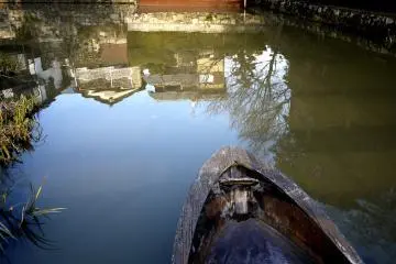 <p>Canal-side buildings reflected in the water</p>
