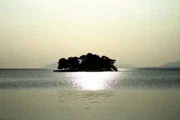<p>The sun is setting in the west but there's still time till sunset. Yomegashima Island is radiant with a silvery hue</p>