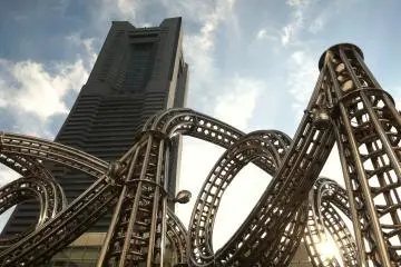 <p>A roller coaster structure in front of Landmark Tower</p>