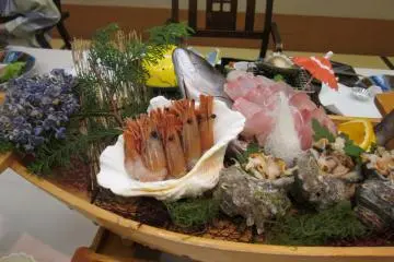 A boat-shaped basket filled with various kinds of fish and seafood all caught locally