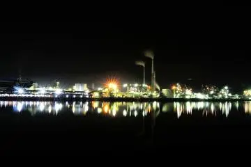 <p>A line of factories at Tokuyama Industrial Region continues close to the estuary on the opposite riverbank</p>