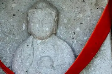 <p>Small jizo statue with serene smile on his face</p>