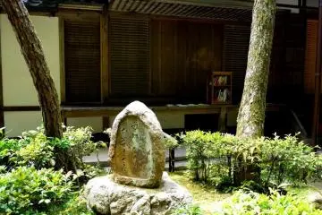 <p>A small bookshelf on the balcony with Buddhist literature</p>