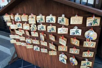 <p>Many Ema (wooden votive tablets) adorn this board</p>