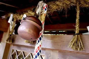 Copper bell and multi-colored rope