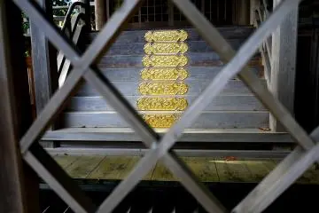 Gold colored metal plating on the wooden steps