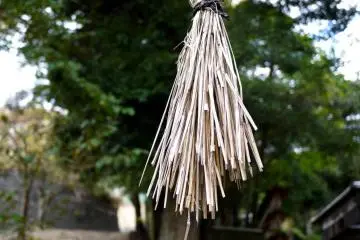 Faded straw rope tassel hanging from the torii