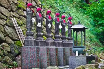 <p>Several `Jizo`, (statues) colorfully decorated in red, just meters away from the entrance to Oyama Temple</p>