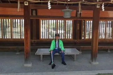 <p>One of the shrine volunteers happily poses for the camera</p>