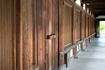 <p>Sebuah pintu kayu dan pagar. Warna coklat mudanya menciptakan suasana yang damai</p>