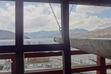 Pray for something and ring the bell three times. From the loft, you can see the lake and a beautiful mountain range beyond it.