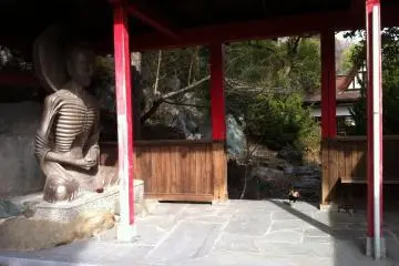 Skeletal Buddha and cockerel