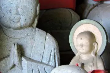 <p>In a group of small jizo statues there's a much smaller one, which looks like a child's statue</p>