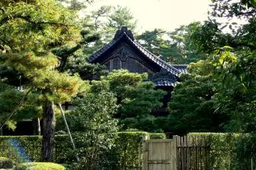 <p>A temple roof behind a closed gate</p>